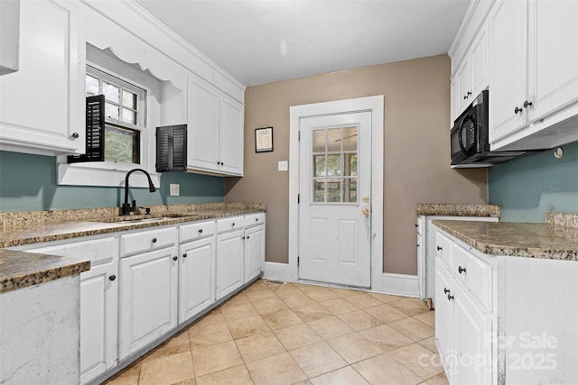 kitchen with white cabinets, light tile patterned floors, and sink