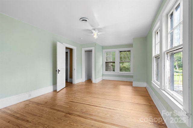 interior space with light hardwood / wood-style floors, plenty of natural light, and ceiling fan