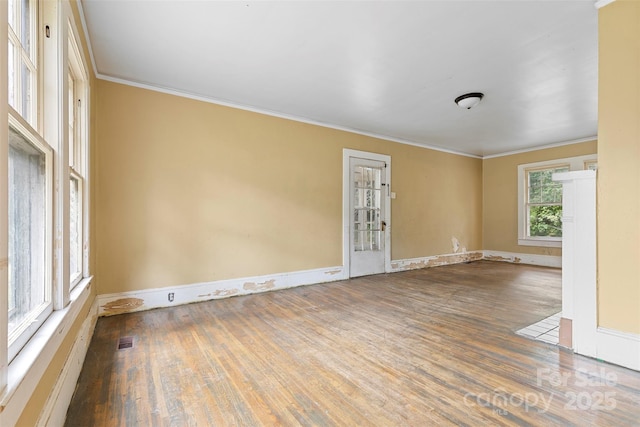 empty room featuring hardwood / wood-style floors and ornamental molding