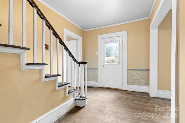 foyer featuring wood-type flooring and ornamental molding