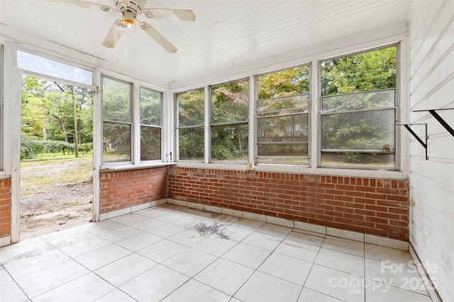 unfurnished sunroom featuring ceiling fan