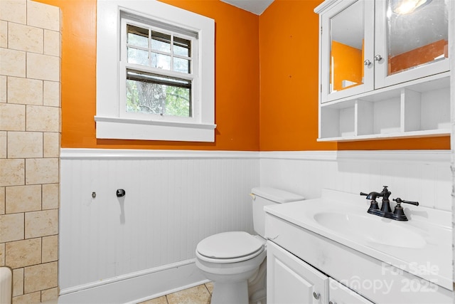 bathroom featuring tile patterned floors, vanity, and toilet