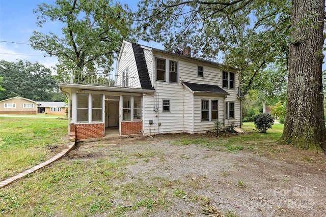 back of house with a sunroom