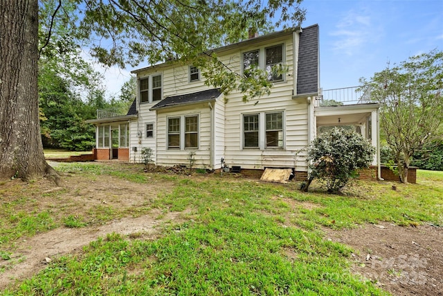 back of property featuring a balcony