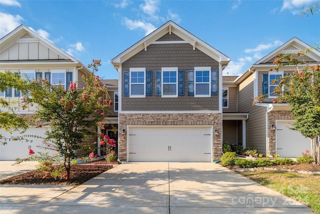 craftsman-style home with stone siding, an attached garage, and concrete driveway