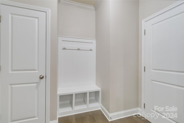 mudroom featuring ornamental molding, baseboards, and wood finished floors