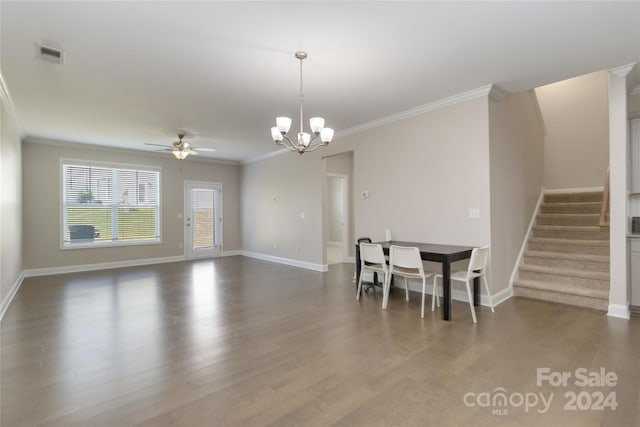 dining area featuring stairs, dark wood-type flooring, ornamental molding, and visible vents