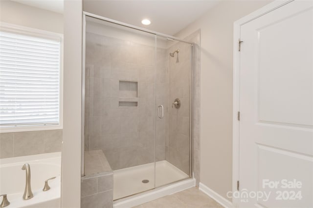 full bathroom with a stall shower, a garden tub, recessed lighting, and tile patterned floors