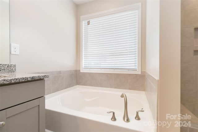 bathroom with a bath and vanity