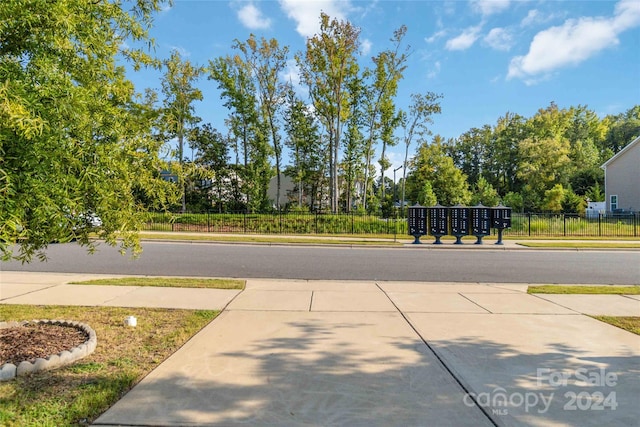 exterior space with concrete driveway and sidewalks