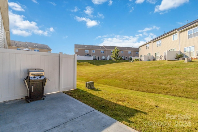 view of yard with a residential view, fence, and a patio