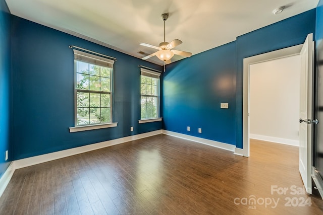 empty room featuring ceiling fan and hardwood / wood-style flooring