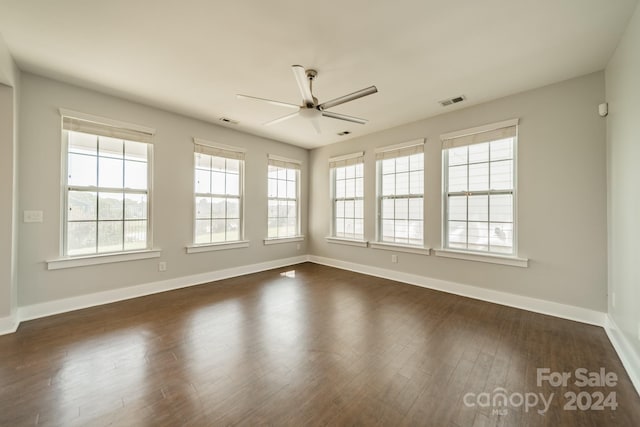 empty room featuring ceiling fan and dark hardwood / wood-style flooring