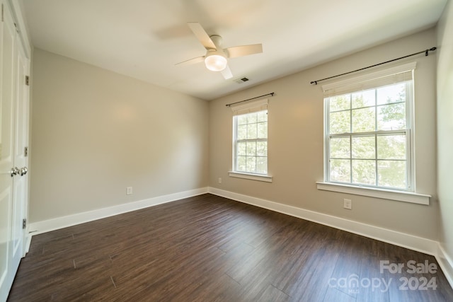 spare room featuring ceiling fan and dark hardwood / wood-style flooring