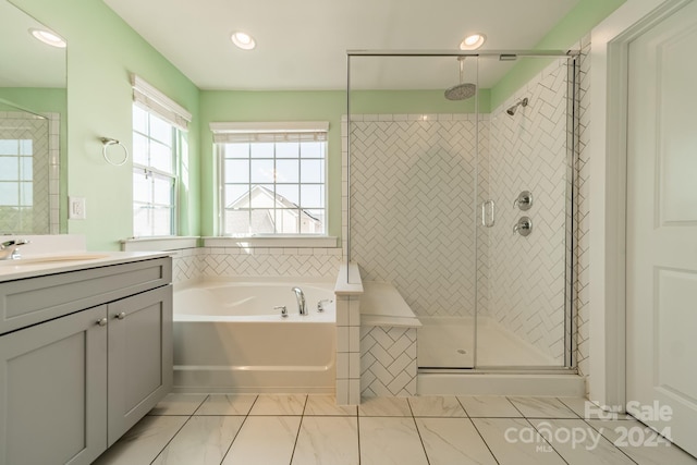 bathroom featuring vanity and shower with separate bathtub