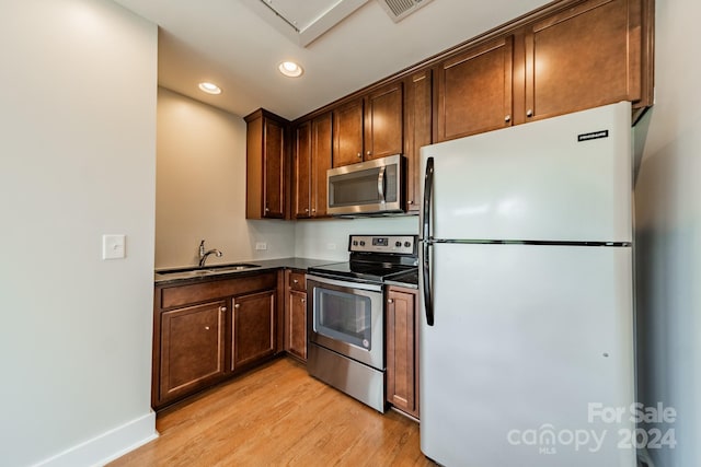 kitchen with light hardwood / wood-style flooring, sink, and appliances with stainless steel finishes