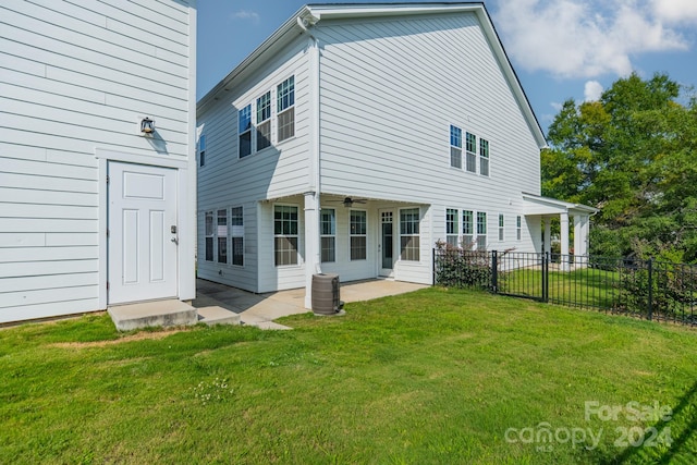 back of house with a lawn and a patio area