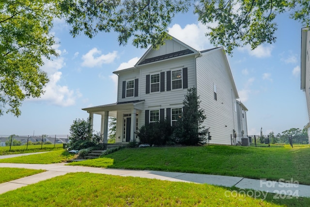 view of front of house featuring a front lawn and covered porch