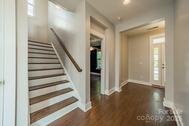 entryway featuring dark wood-type flooring and ceiling fan