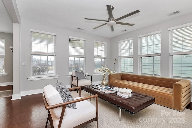 living room featuring ceiling fan and dark hardwood / wood-style flooring