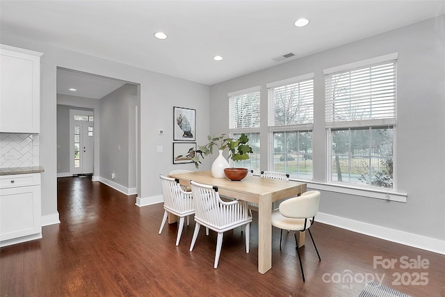 dining space with dark hardwood / wood-style flooring