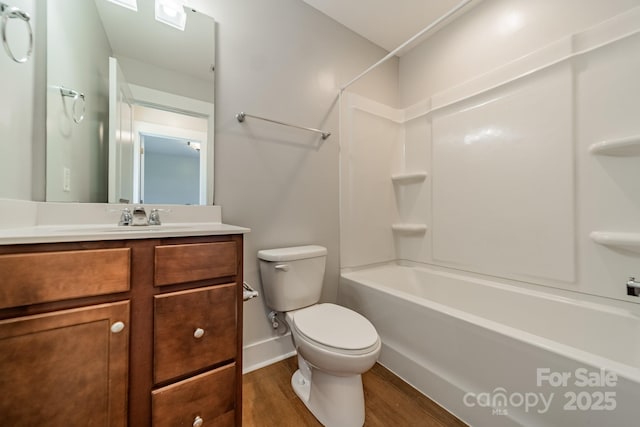 full bathroom featuring hardwood / wood-style flooring, vanity, shower / tub combination, and toilet