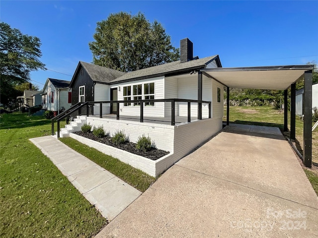 view of home's exterior with a lawn and a carport