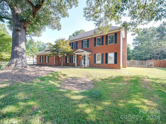 colonial-style house with a front lawn