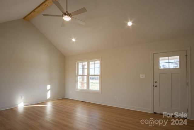 entryway with beamed ceiling, ceiling fan, a healthy amount of sunlight, and light hardwood / wood-style flooring