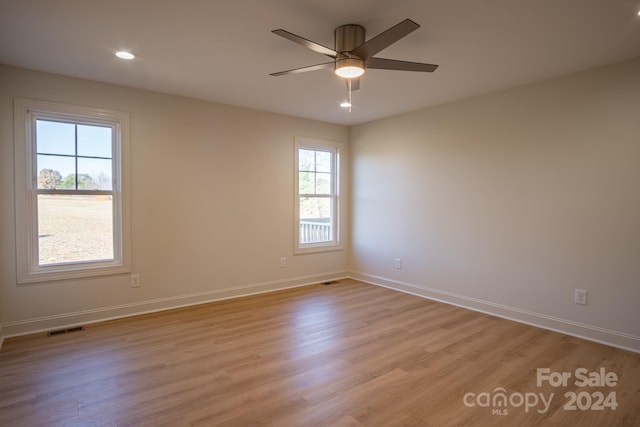 spare room featuring light wood-type flooring and ceiling fan