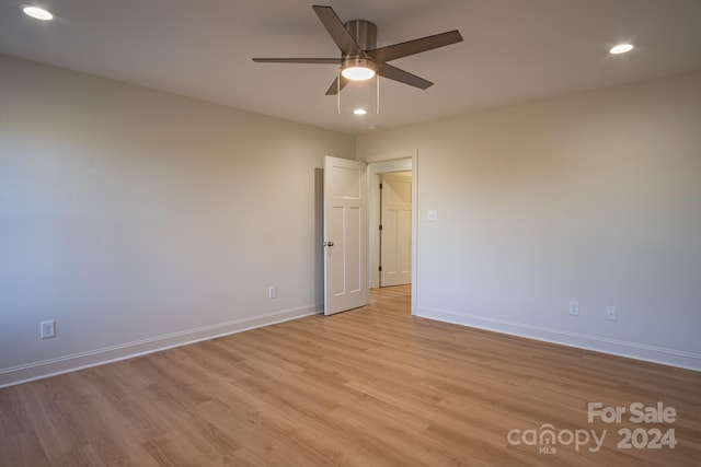 spare room featuring ceiling fan and light wood-type flooring