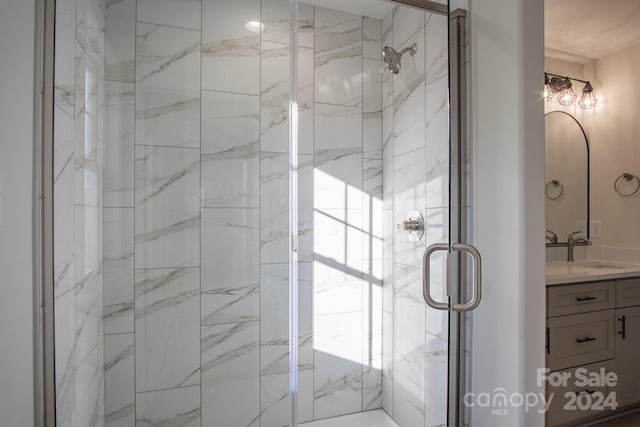 bathroom with vanity and a shower with door