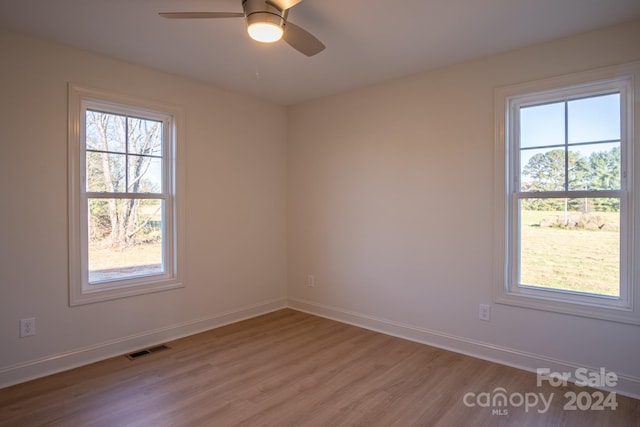 unfurnished room with light wood-type flooring and ceiling fan