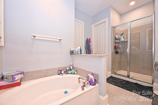 bathroom featuring plus walk in shower and tile patterned flooring