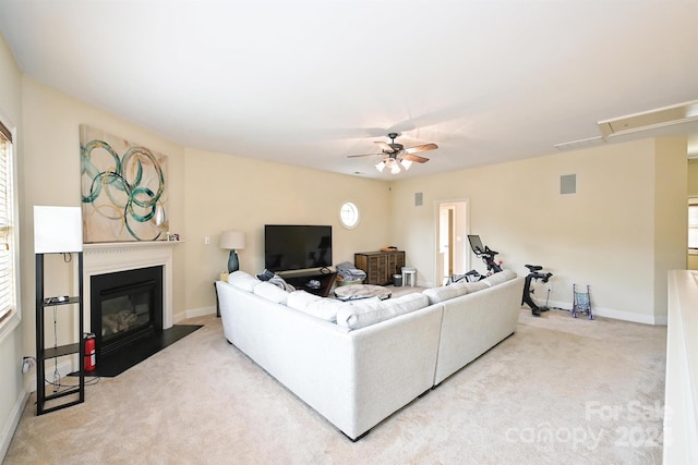 living room featuring carpet floors, a healthy amount of sunlight, and ceiling fan