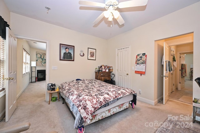 carpeted bedroom with a closet and ceiling fan