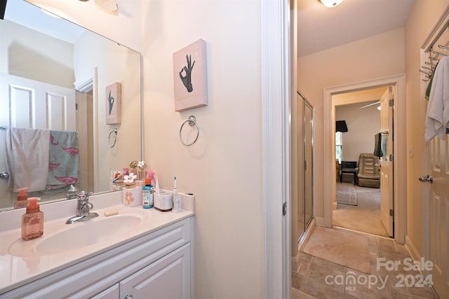 bathroom featuring vanity and a shower with door