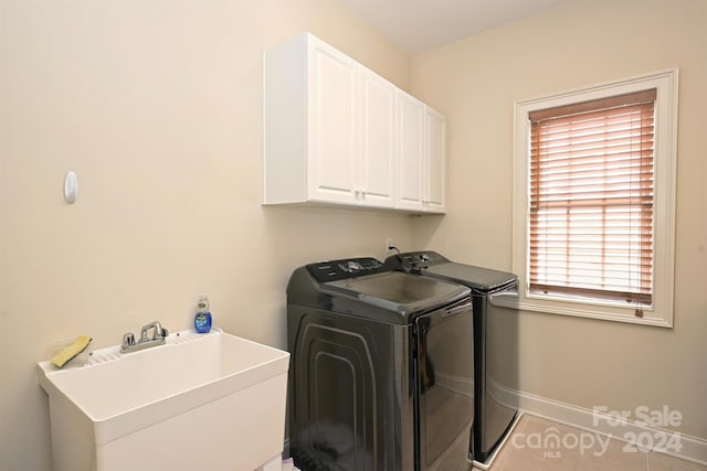 laundry room featuring cabinets, sink, washing machine and dryer, and light tile patterned flooring