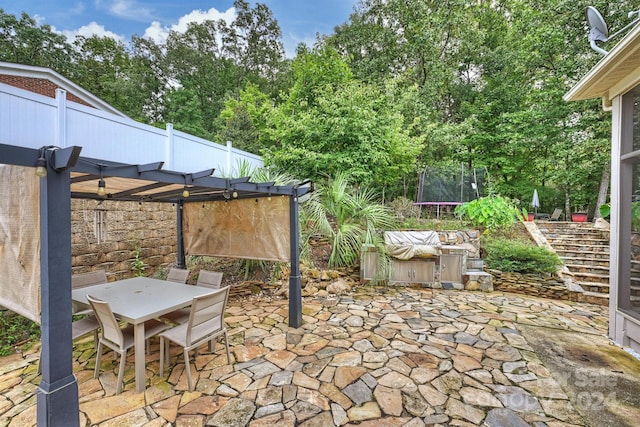 view of patio featuring a pergola and a trampoline