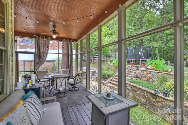 sunroom featuring wooden ceiling, ceiling fan, and plenty of natural light