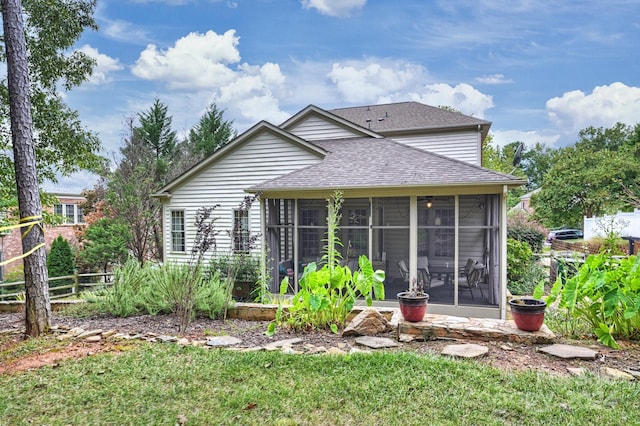 rear view of house featuring a sunroom