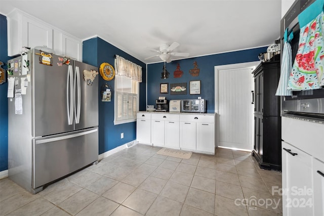 kitchen featuring ceiling fan, white cabinetry, stainless steel refrigerator, and light tile patterned flooring