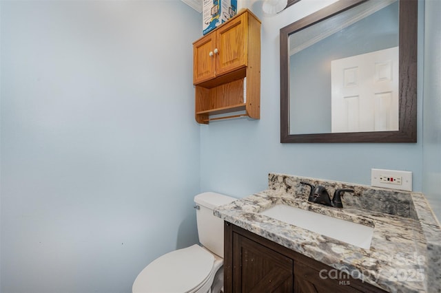 bathroom with vanity, toilet, crown molding, and vaulted ceiling