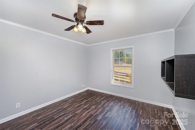 empty room featuring ceiling fan, ornamental molding, and dark wood-type flooring