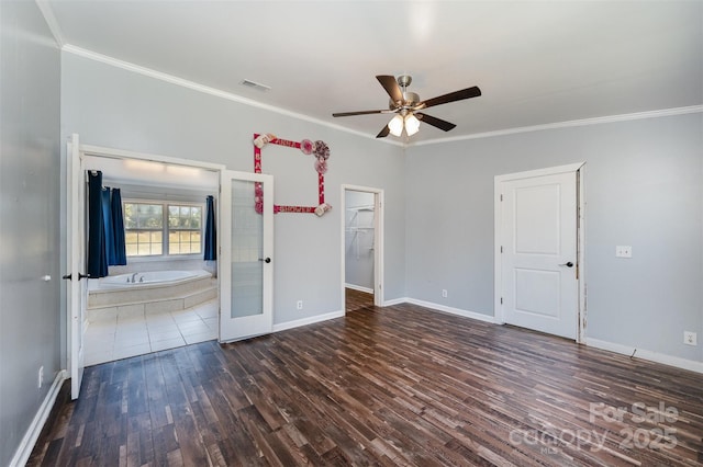 empty room with crown molding, french doors, ceiling fan, and dark wood-type flooring