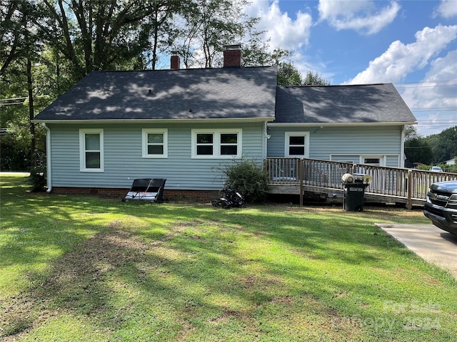 back of house with a wooden deck and a yard