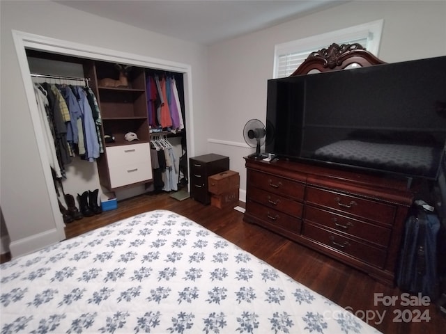 bedroom featuring a closet and dark hardwood / wood-style flooring