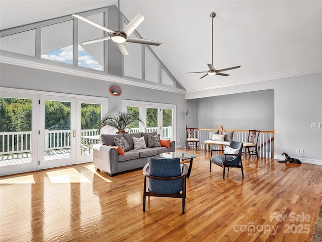 living room featuring ceiling fan, light hardwood / wood-style flooring, french doors, and high vaulted ceiling