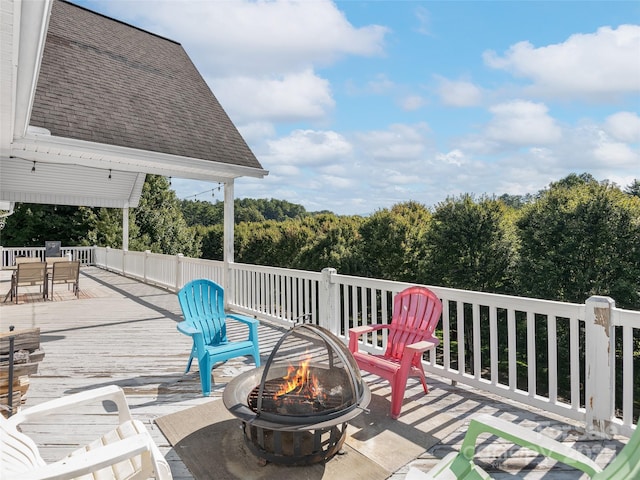 view of patio featuring a wooden deck and a fire pit