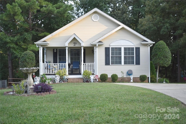 bungalow-style house with a porch and a front lawn